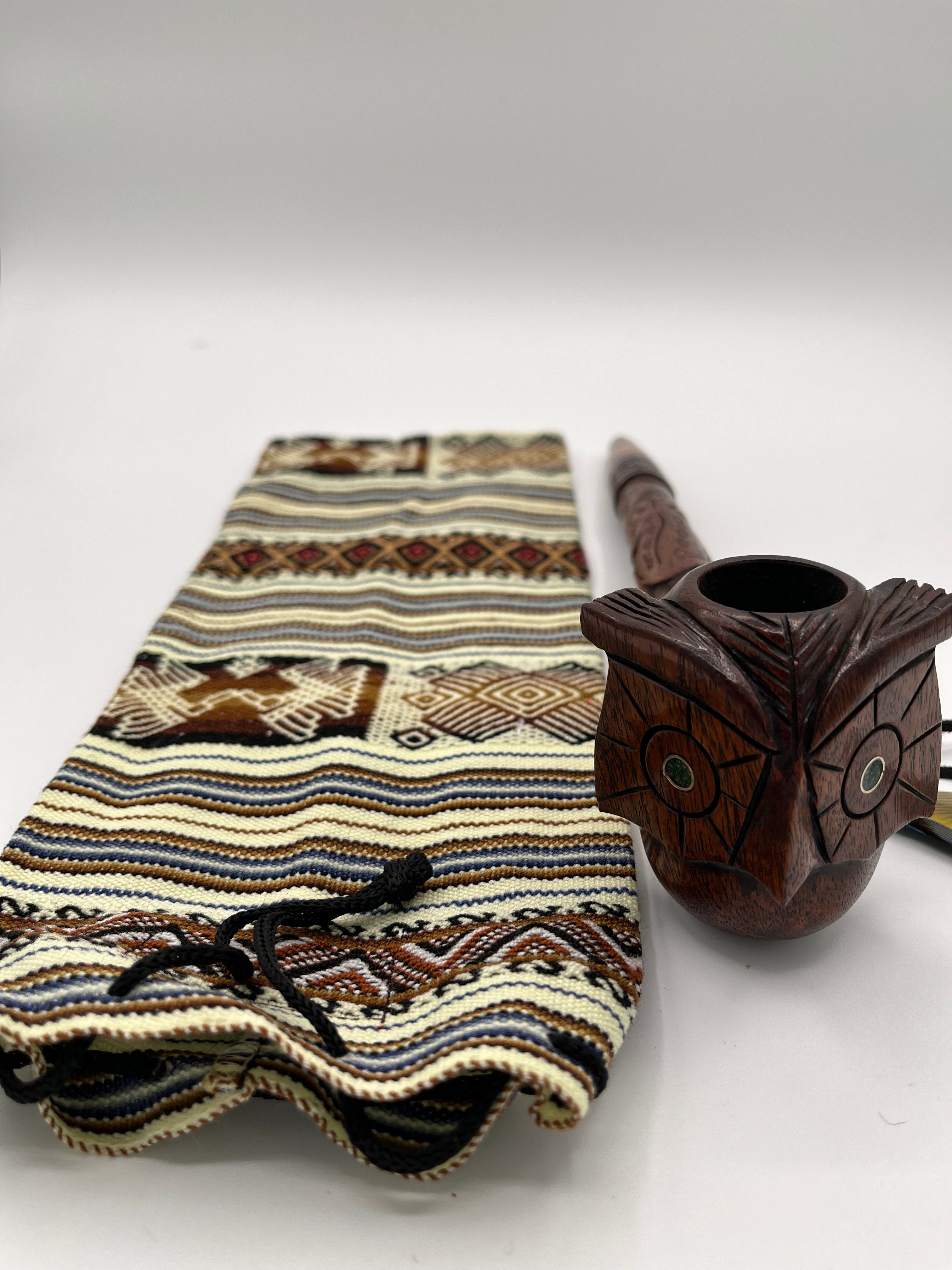 Front view of owl peace pipe with engraved jade stone eyes, handmade drawstring bag to carry safely. 