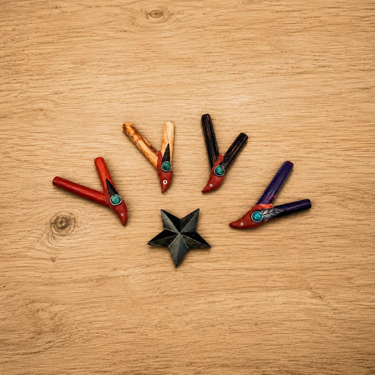 Bird Kuripe handcrafted from four Amazonian hardwoods with chrysocolla gemstone accents, displayed as a collection.