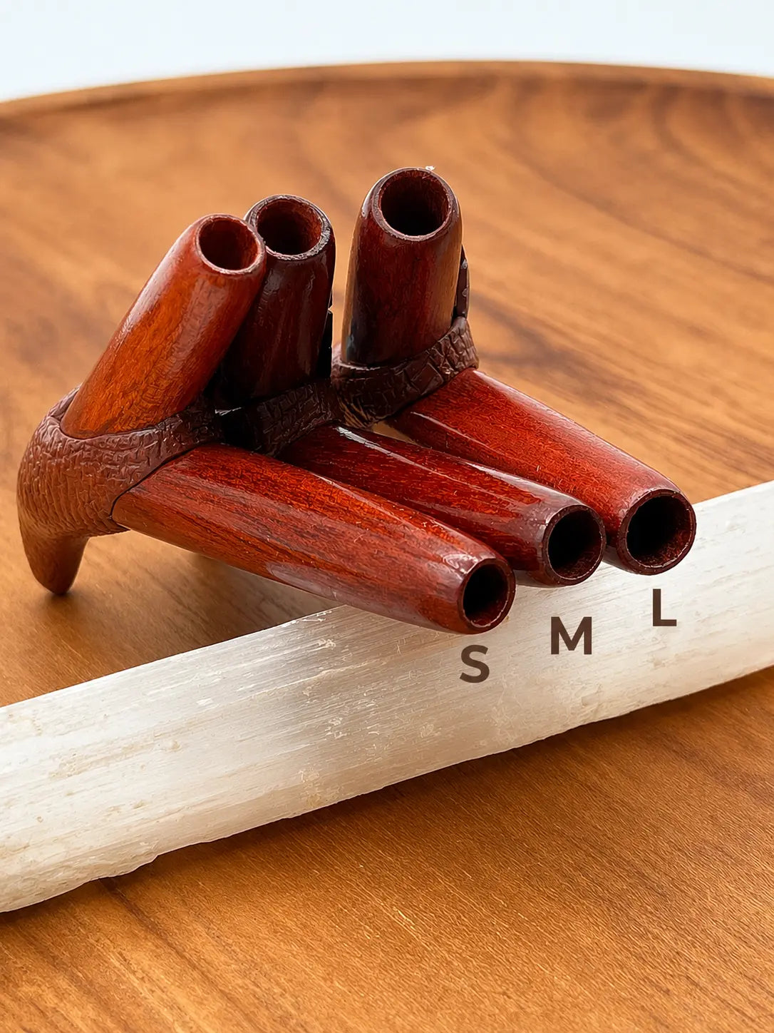 Handcrafted Bird Kuripe Hapé self-applicator in palo sangre (amazonian redwood) arranged by nostril size.
