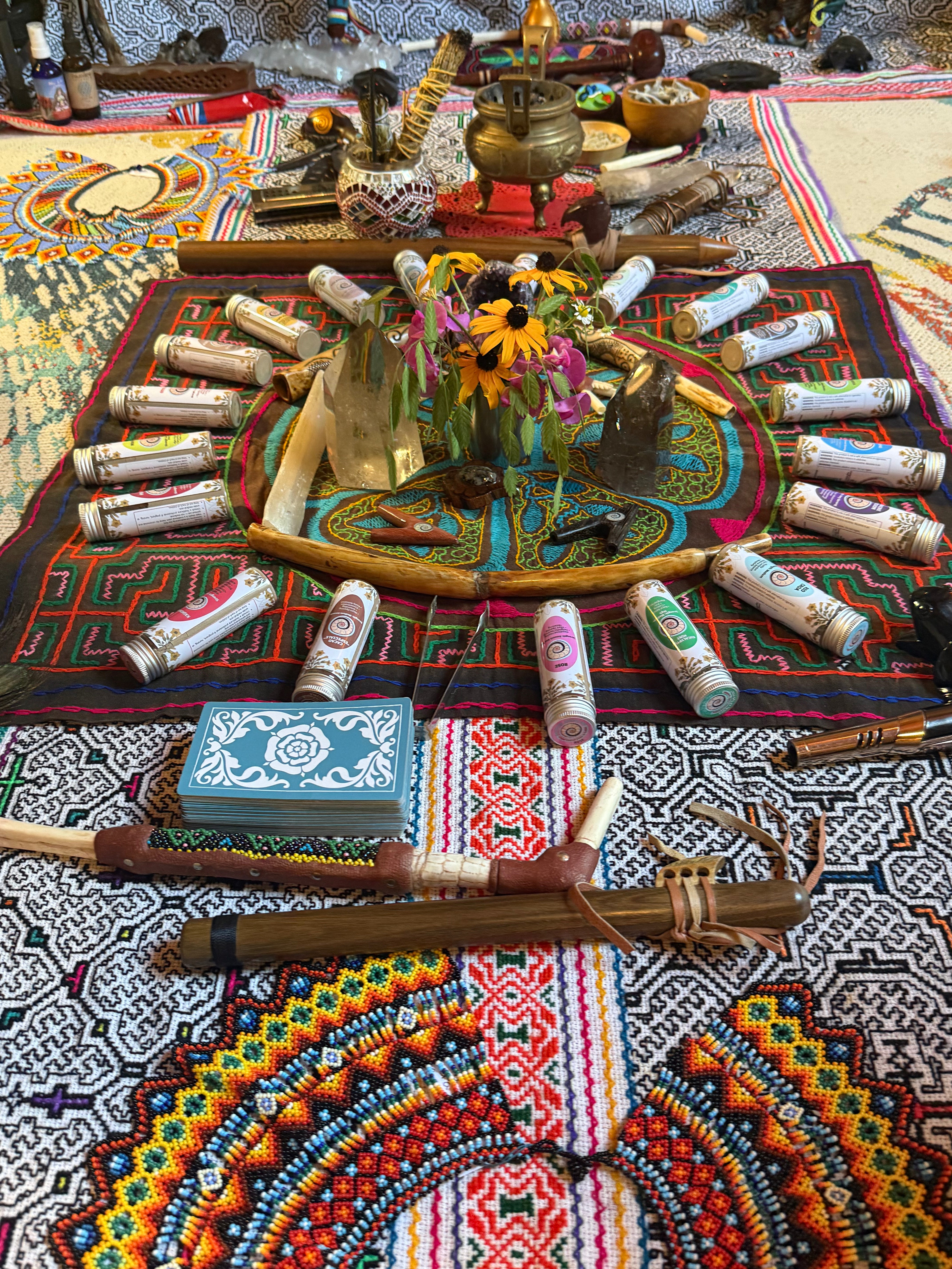 Build Your Own Hapé Bundle by Collective Journey Art; a ceremonial altar with colorful Shipibo Patterns, handcrafted tepis and kuripes, hapé jars arranged in a circle around crystals and forest flowers, symbolizing prayer, medicine, and connection.