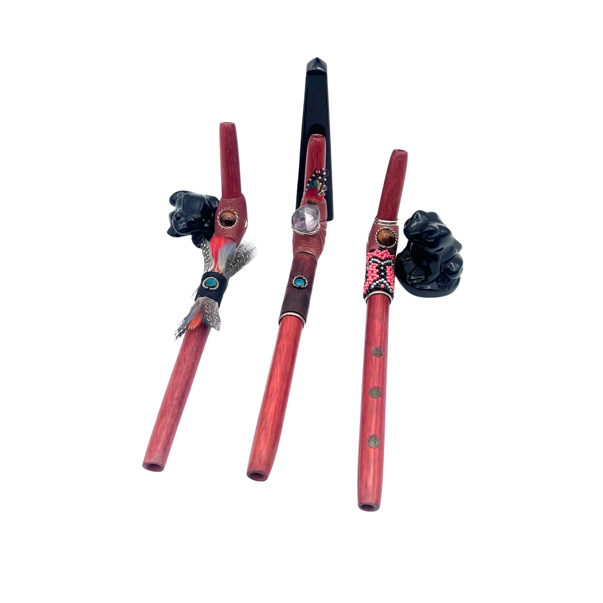 three designs Tepi L beaded, leather and feather, made of Palo Sangre, amazonian redwood