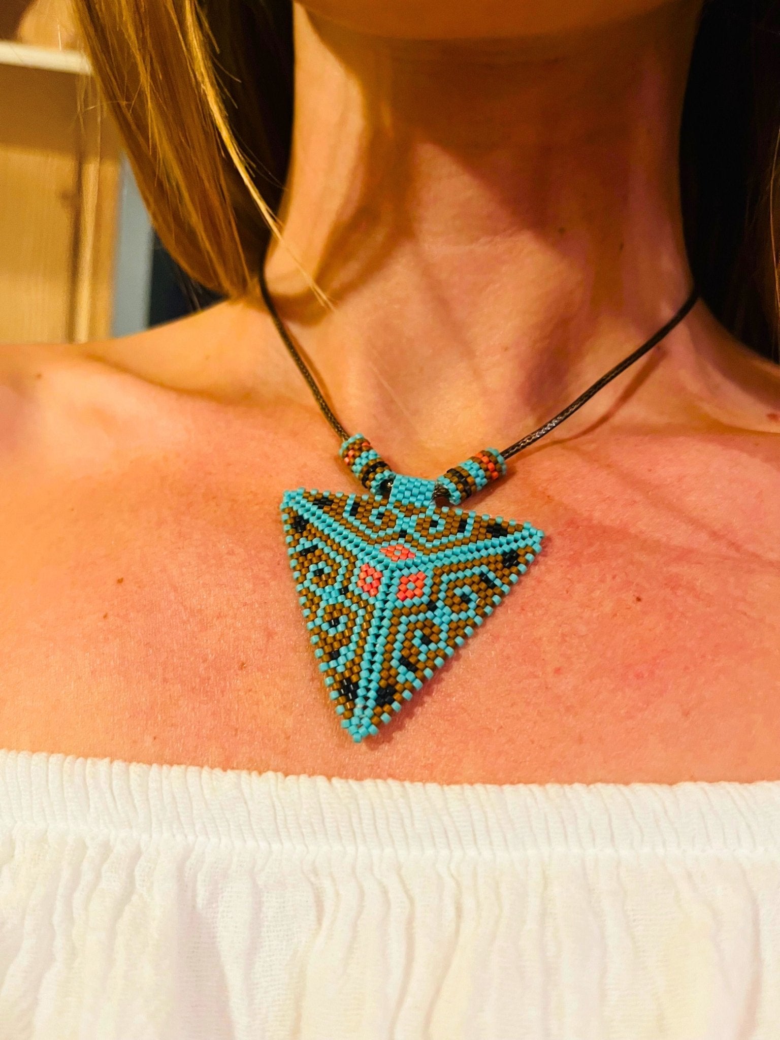 Handcrafted Pyramid of the Third Eye beadwork pendant worn as a necklace, choker, or ceremonial headpiece, created by Indigenous artisans within the Collective Journey Art community.