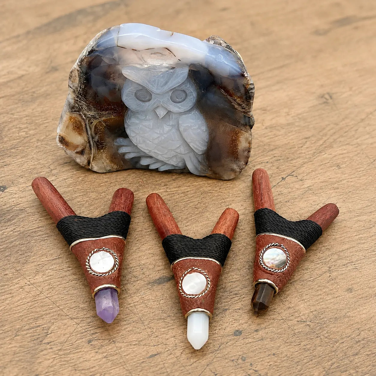 Three handcrafted Red Rocket Kuripe Hapé self-applicators made from reclaimed redwood with black waxed thread, mother-of-pearl shell accents, and Amethyst, Moonstone, or Tiger’s Eye crystal points.