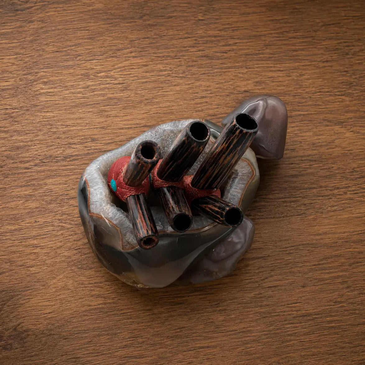 Three handcrafted Wizard Kuripes arranged to compare the available gauge sizes, featuring dark hardwood, turquoise stone inlays, and clear quartz crystal accents.